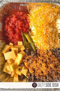 an assortment of cheeses and other foods in a plastic container