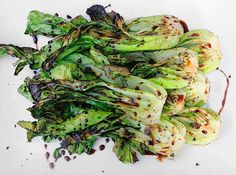 a pile of broccoli sprouts sitting on top of a white plate