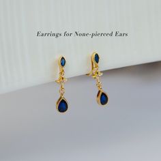 Crystal Dark Blue Diamond Dangle Earrings, Gold Plated CZ Clip On Earrings, Dainty Navy Gem Clip On Drop Ear Clips, Non Pierced Earrings, Coil Back Clip On Earrings --------------------- -DETAILS- * Material: gold plated brass, cubic zirconia * Dimensions: 5*24 mm * Sold as a pair Our clip on earrings gives you all variety and elegance of pierced earrings with all the convenience and comfort. New unique spiral clip on design, much more comfortable to wear.  Every clip on earrings come with non s Clip On Dangle Earrings, Blue Diamond Earrings, Dark Blue Earrings, Non Pierced Earrings, Ear Parts, Dangle Earrings Gold, Gift Ribbon, Ear Clips, Diamond Dangle Earrings