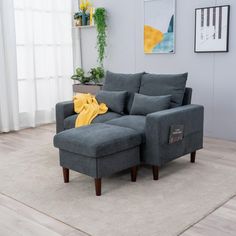 a gray couch sitting on top of a wooden floor