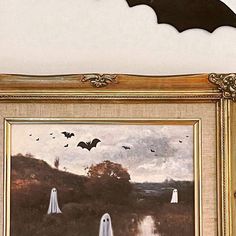 there is a painting on the wall with bats flying above it