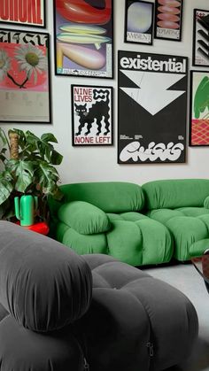 a living room filled with green couches and pictures on the wall above it's headboard