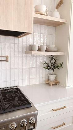 a stove top oven sitting inside of a kitchen next to white counter tops and cabinets