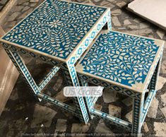 two tables with blue and white designs on them