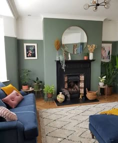 a living room filled with furniture and a fire place next to a mirror on the wall