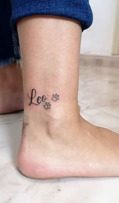 a woman's foot with the word love written on it and four clovers