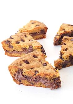 chocolate chip cookie bars cut in half on a white surface