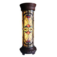 a lamp that is sitting on top of a wooden stand with a stained glass window