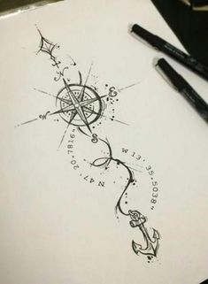 a pen and ink drawing of an anchor, star and compass on paper with two black markers