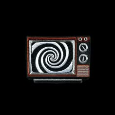 an old fashioned television with a spiral design on it