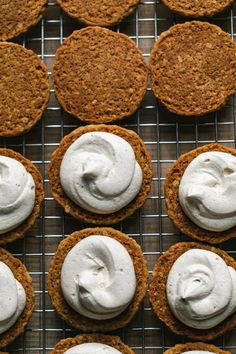 several cookies with white frosting on a cooling rack