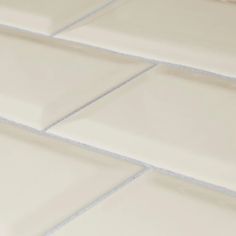 a close up view of a white tile floor with no grouting on it