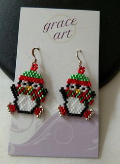 the penguin is wearing a red hat and green scarf with beads on it's ear