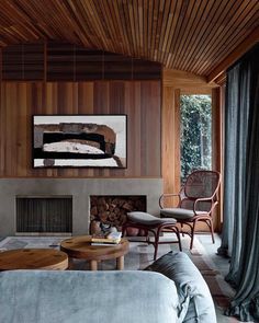 a living room filled with furniture and a fire place in front of a painting on the wall