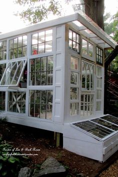 a white house with lots of windows in the yard