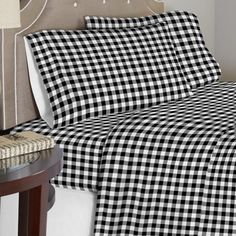 a black and white checkered comforter set on a bed