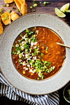 a bowl of chili with tortilla chips on the side