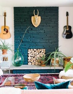 a living room filled with lots of furniture and plants on top of a fireplace mantel