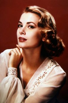 a woman with her hand on her chin and the words grace kelly above her head