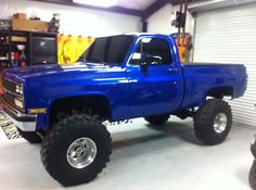 a large blue truck parked in a garage