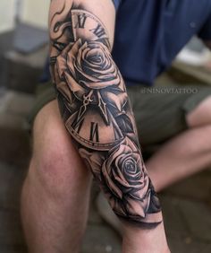 a man with a clock and roses tattoo on his arm