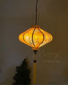 a yellow lamp hanging from the ceiling in a room