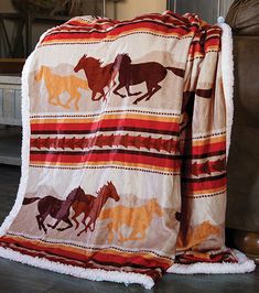 a blanket that has horses on it