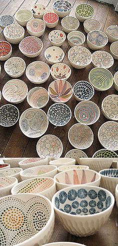 many bowls are sitting on the floor in front of each other