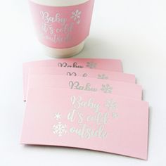 three baby it's cold outside cards next to a coffee cup