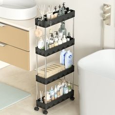 a bathroom with a bath tub and three tiered shelving unit