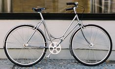 a bicycle parked in front of a store window