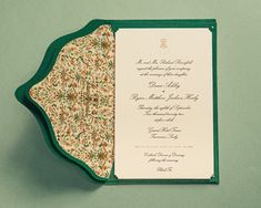 the inside of a green and white wedding card with an ornate design on it's front