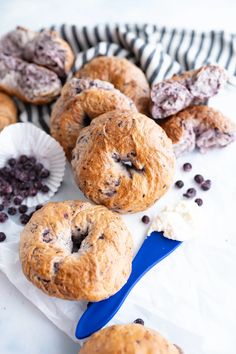 blueberry muffins and other pastries on a table