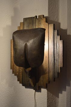 an elephant head mounted to the side of a wall with wood planks on it