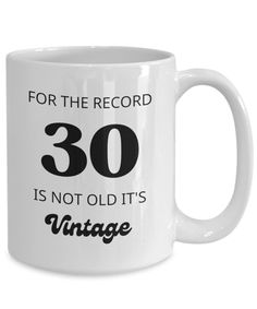 a white coffee mug that says for the record 30 is not old it's vintage