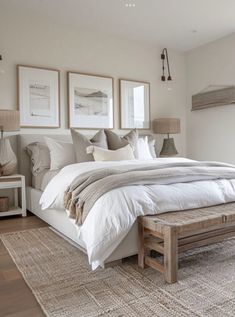 a large bed sitting in a bedroom next to a wooden foot board on top of a hard wood floor