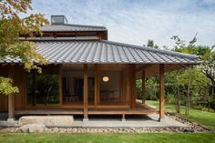 a small wooden building sitting on top of a lush green field