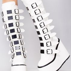 They Won’t Be Able To Get Enough Of You In The Addiction Platform Boots From Demonia. These Intoxicating Festival Boot Feature A White Vegan Leather Upper, Buckle Up Front With 8 Straps, Black Hardware And Trim, And Back Zipper Closure. You In These Cute Boots Will Be A Euphoria Better Than Any Drug Can Give! Addiction Platform Boots 5 1/2"" Platform Vegan Leather Knee High Boot 8 Buckle Straps W/ Metal Plates Detail Black Hardware & Trimback Metal Zip Closure White/Black White Platform Boots With Pointed Toe And Reinforced Heel, White Platform Boots With Pointed Toe, White Synthetic Platform Boots With Pointed Toe, White Synthetic Pointed Toe Platform Boots, White Leather Platform Boots With Pointed Toe, White Platform Boots With Wedge Heel, White Closed Toe Platform Boots For Party, White Leather Platform Boots With High Heel, White Wedge Heel Boots For Spring