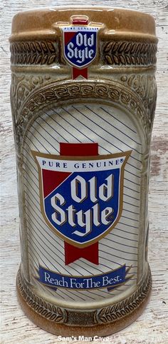 an old style beer can sitting on top of a wooden table