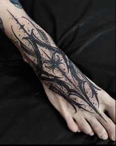 a person's foot with tattoos on it and an ink pen in the middle