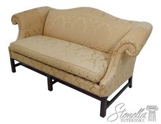 a tan couch sitting on top of a wooden frame