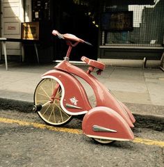 an old scooter is parked on the side of the street