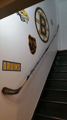 hockey stickers on the wall next to an escalator