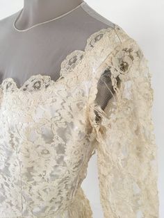 an old fashioned dress with lace on it