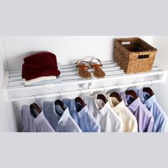 an organized closet with clothes and shoes hanging on the rack, including slippers and sandals