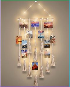 a wall hanging with pictures and string lights