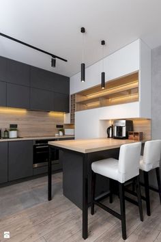 a kitchen with white chairs and wooden counter tops