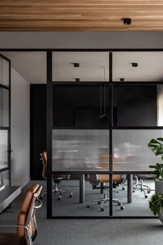 an office with black walls and glass doors