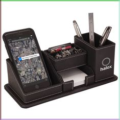 a cell phone and pen holder on a desk