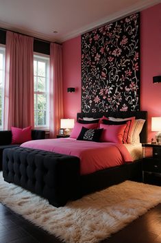 a bedroom decorated in pink and black with flowers on the wall above the bed, along with two night stands